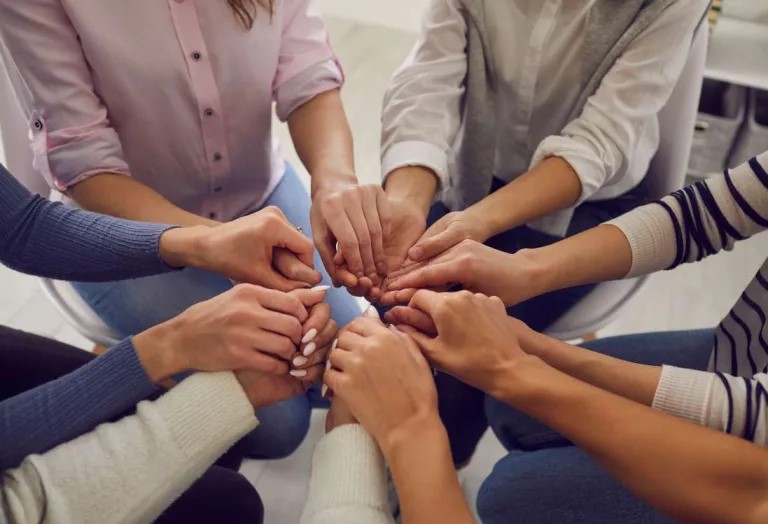 Group Of People Holding Hands Together