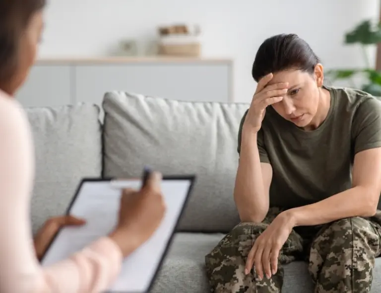 Female Soldier In Therapy Session Looking Distressed
